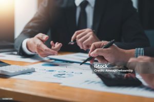 business people doing calculations analyze the work at the meeting